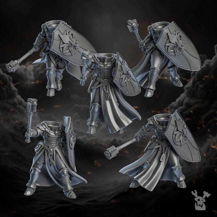 Four metallic fantasy warrior figurines on a dark background